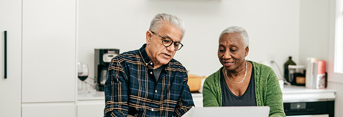Senior couple using online banking